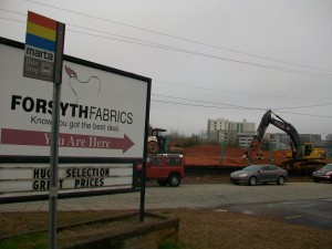A new apartment complex is being built along Huff Road, near the iconic Forsyth Fabrics. Credit: David Pendered