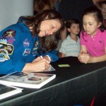Photo of astronaut Tracy Caldwell Dyson signing autographs for schoolchildren April 18 at Fernbank Science Center.