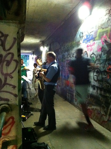 Photo of a runner passing by the Sacre du Krog performance in the Krog Street tunnel.