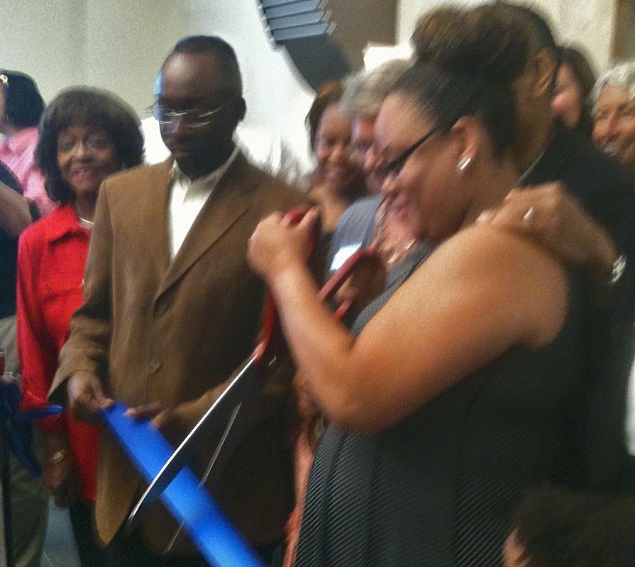 Photo of Brandy Brown Rhodes cutting the ribbon dedicating the Derwin Brown Police Precinct on June 28.