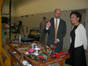 Mark McJunkin, director of operations of the Global Center for Medical Innovation, shows Penny Pritzker his tools (Photo by Maria Saporta)