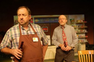 Photo of Charlie, a local grocer (played by William S. Murphey), and Malcolm (Tom Thon), who part ways over the mayor's efforts to placate anti-refugee residents. Sidington, is a fictional recreation of Clarkston and the play recounts actual events in the metro Atlanta hamlet. Credit: Third Country, 2013, Horizon Theatre Company.
