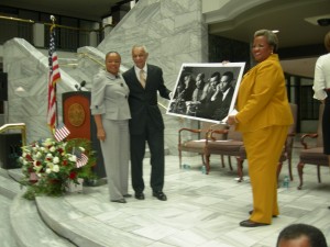 Elisabeth Omilami presents photo of a younger C.T. Vivian with Andrew Young and her father, Hosea Williams