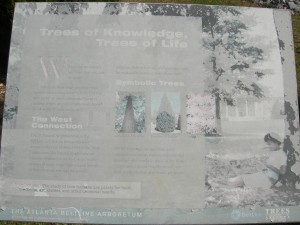 Weather-worn sign says: "Trees of Knowledge, Trees of Life" It was put there by Trees Atlanta and the Atlanta BeltLine to highlight the trees on the southwest corridor and the Arboretum