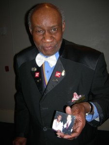 Albert "Smitty" Smith — Mr. Hospitality — holds up a photo of him and Maynard Jackson in Barcelona from 1992