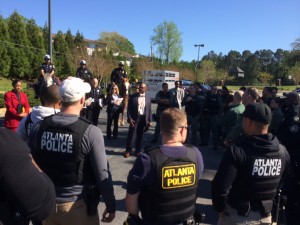 Atlanta police officers are briefed before they canvas for clues in four killings committed east of the intersection of I-285 and Martin Luther King Jr. Drive. Credit: David Pendered