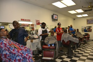 The barbers in this shop at Mall West End are so sought after that two dozen patrons waited their turn in a chair. Credit: Donita Pendered