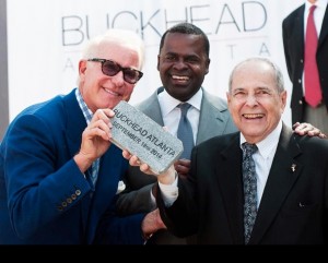 Atlanta's economic recovery is fueled by new developments such as Buckhead Atlanta. Pictured here installing an honorary brick on opening day were Atlanta Mayor Kasim Reed (center), former Atlanta Mayor Sam Massell, and Dene Oliver, CEO of Oliver McMillan, the development company that opened Buckhead Atlanta. Credit: Oliver McMillan