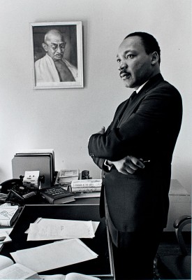 Martin Luther King Jr. with framed portrait of Gandhi. Credit: Photo by Bob Fitch