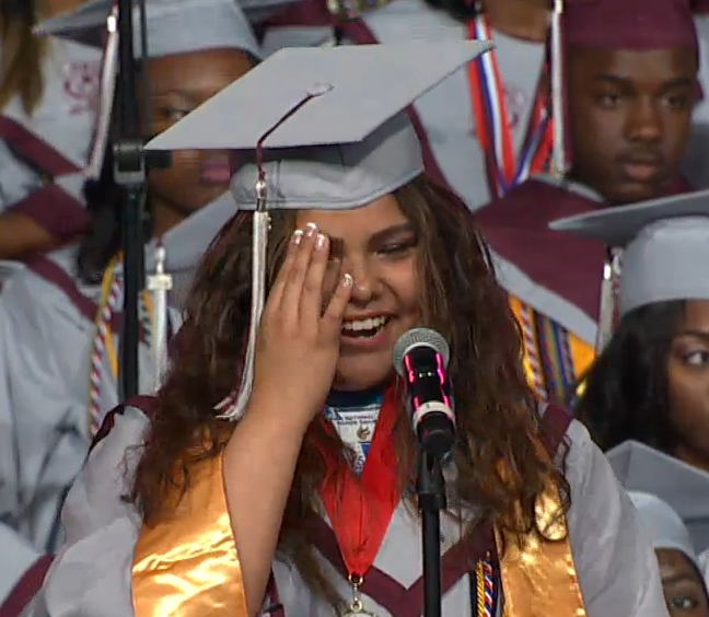 Photo of an emotional Vanessa Badillo-Rodriguez speaking Friday as valedictorian of Carver School of the Arts.