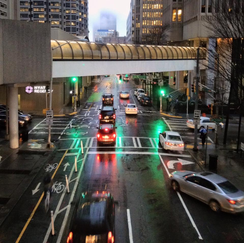 A cyclist navigates Peachtree Center in the rain- by Darin aka ATL Urbanist