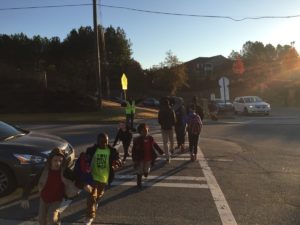 Crossing guards halt traffic as students as they walk to and from Charles R. Drew Charter School. Credit: The Georgia Conservancy