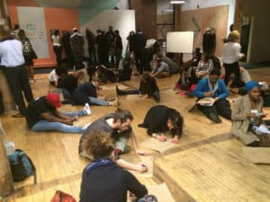 Folks spread out on the floor to participate in a public community meeting at the Center for Civic Innovation. Credit: Center for Civic Innovation
