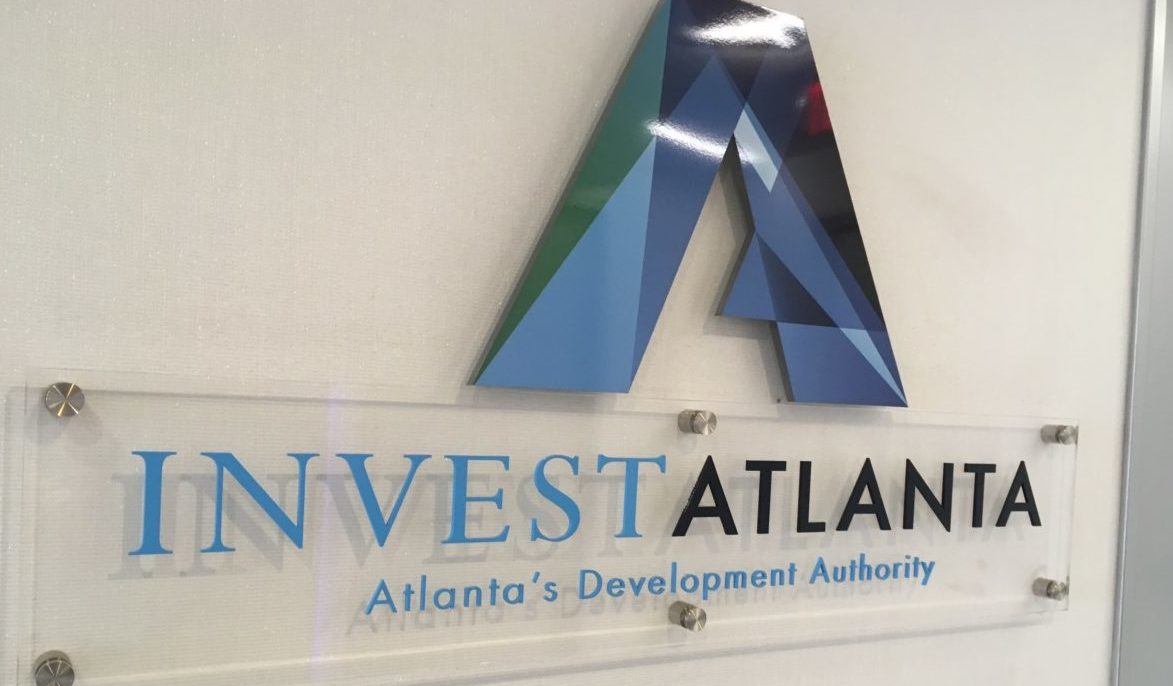 A photo of the Invest Atlanta logo on a wall