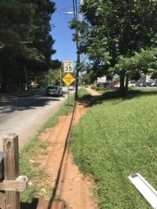 Pedestrians have worn a rut that serves as a pathway along Campbellton Road, a short distance west of Fort McPherson. Credit: David Pendered