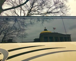 The Gold Dome of the state Capitol reflected in a bus window. Credit: Kelly Jordan