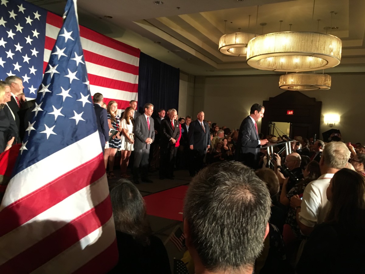 After a rough primary season, Georgia GOP Chairman John Watson emceed a Republican unity rally Thursday, with numerous party leaders on stage and rallying a crowd. Credit: Maggie Lee