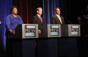 Candidates for Georgia Governor from left; Democrat Stacey Abrams, Republican Sec. of State Brian Kemp, and Libertarian Ted Metz, right, during a pause in a debate on Tuesday, Oct. 23, 2018, in Atlanta. Credit: AP Photo/John Bazemore