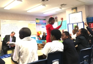 Atlanta Youth Academy fifth-grade teacher high-fives students after a mental math exercise on Wednesday, during a visit by the lieutenant governor. Credit: Maggie Lee