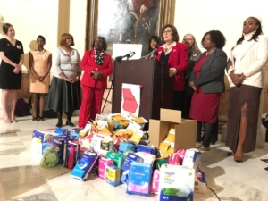 State Rep. Debbie Buckner, D-Junction City, speaking at the state Capitol on Tuesday, joined others in calling for an end to the state sales tax on menstrual products. Credit: Maggie Lee