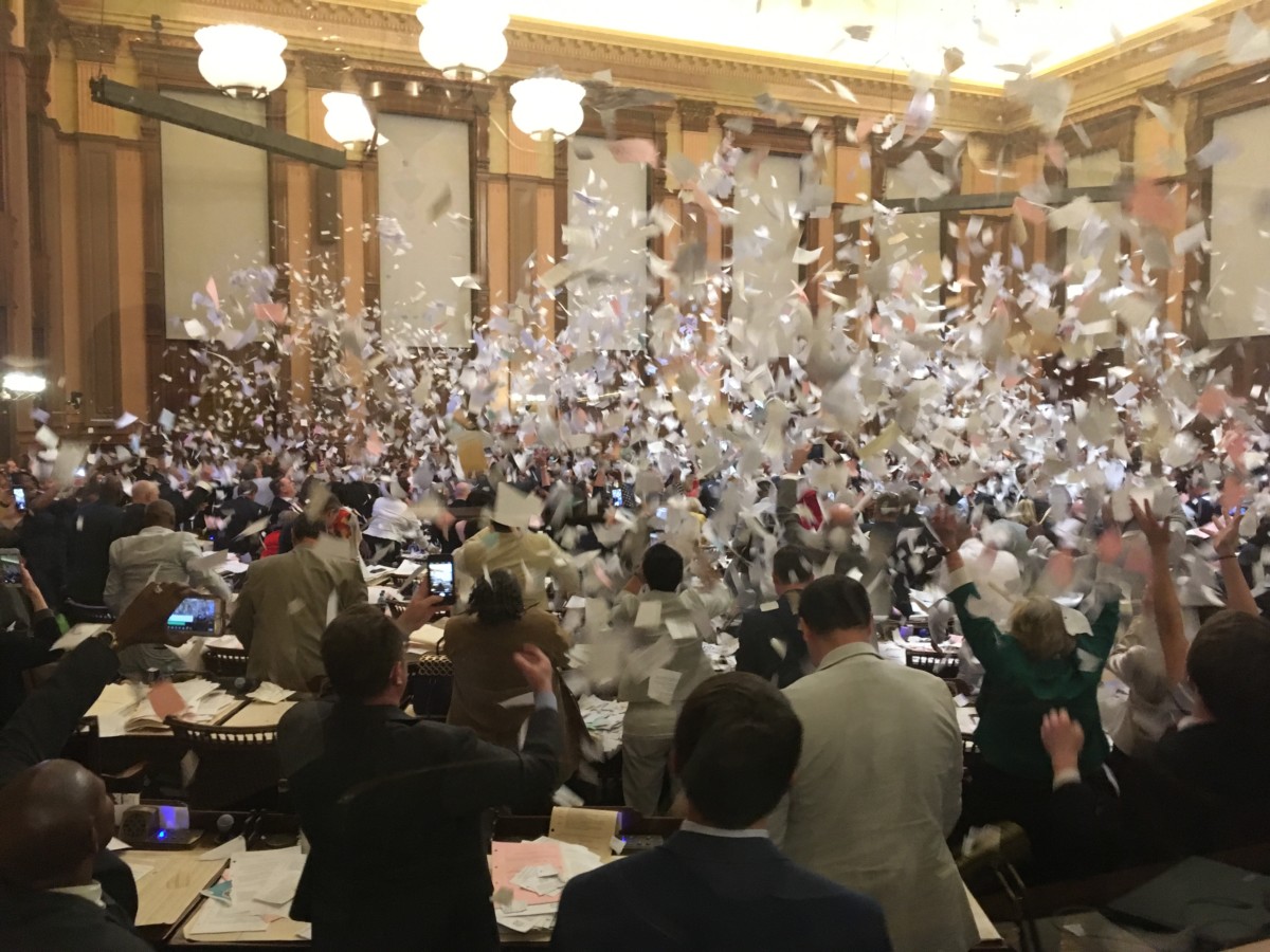 After voting on the medical cannabis cultivation bill, the House gave itself a standing ovation — then about 15 minutes later, they threw shredded paper in the air and joyously adjourned for the year. Credit: Maggie Lee
