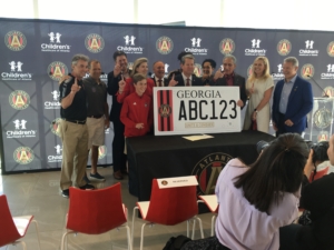 Gov. Brian Kemp (center front) plus Atlanta United management and other fans at the bill-signing on May 6. Credit: Maggie Lee
