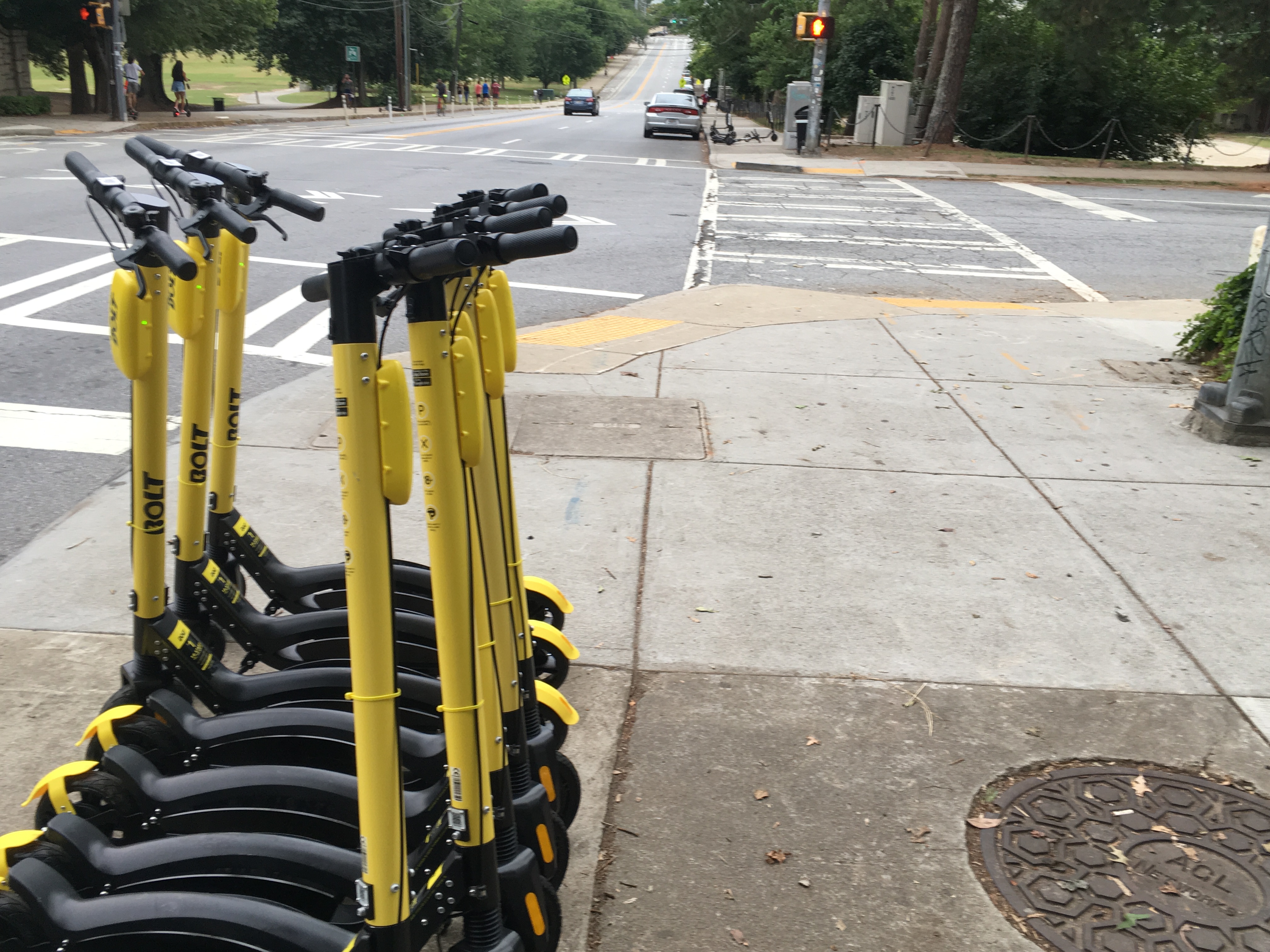 A row of yellow scooters parked by by Piedmont Park. Credit/file: Maggie Lee