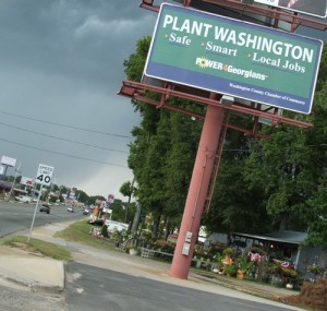 A billboard reads "Plant Washington: Safe Smart Local Jobs"