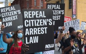 Marchers in Atlanta carry signs reading "Repeal Citizen's Arrest Law"