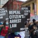 Marchers in Atlanta carry signs reading "Repeal Citizen's Arrest Law"