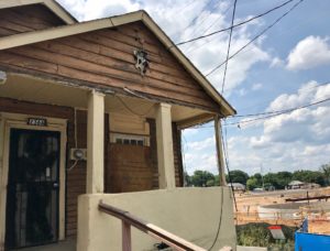 A dilapidated house by the Cook Park construction site in 2018. The park represents an investment in a neighborhood that has, in parts, been left behind by prosperity. (File/Credit: Kelly Jordan)