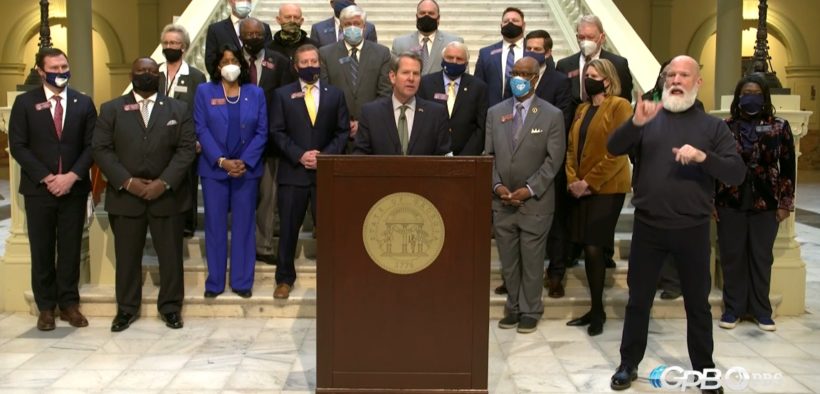 A bipartisan group of lawmakers stand with Republican Gov. Brian Kemp Tuesday as he announced plans to curtail Georgia's citizen's arrest law. (Credit: screenshot)