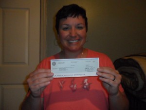 Christal Presley with her water overpayment check from the city of Atlanta.