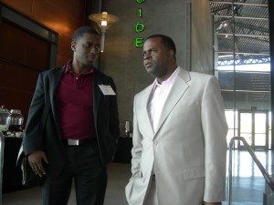 Wole Ralph, vice chairman of the Clayton Commission, confers with Atlanta Mayor Kasim Reed during LINK trip