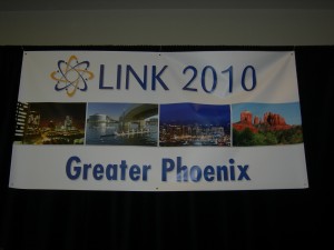 A picture of LINK banner hanging over group during closing exercises
