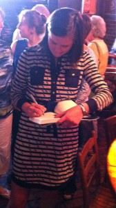 Wilkinson, 29, signing "Between God & Green" at Manuel's Tavern on July 14. She graduated from nearby Paideia School.